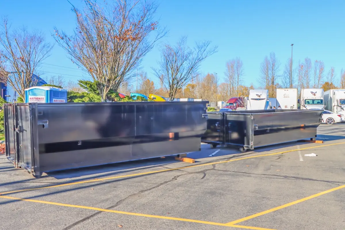 Professional dumpster rental service with roll-off container on residential driveway in St. Robert
